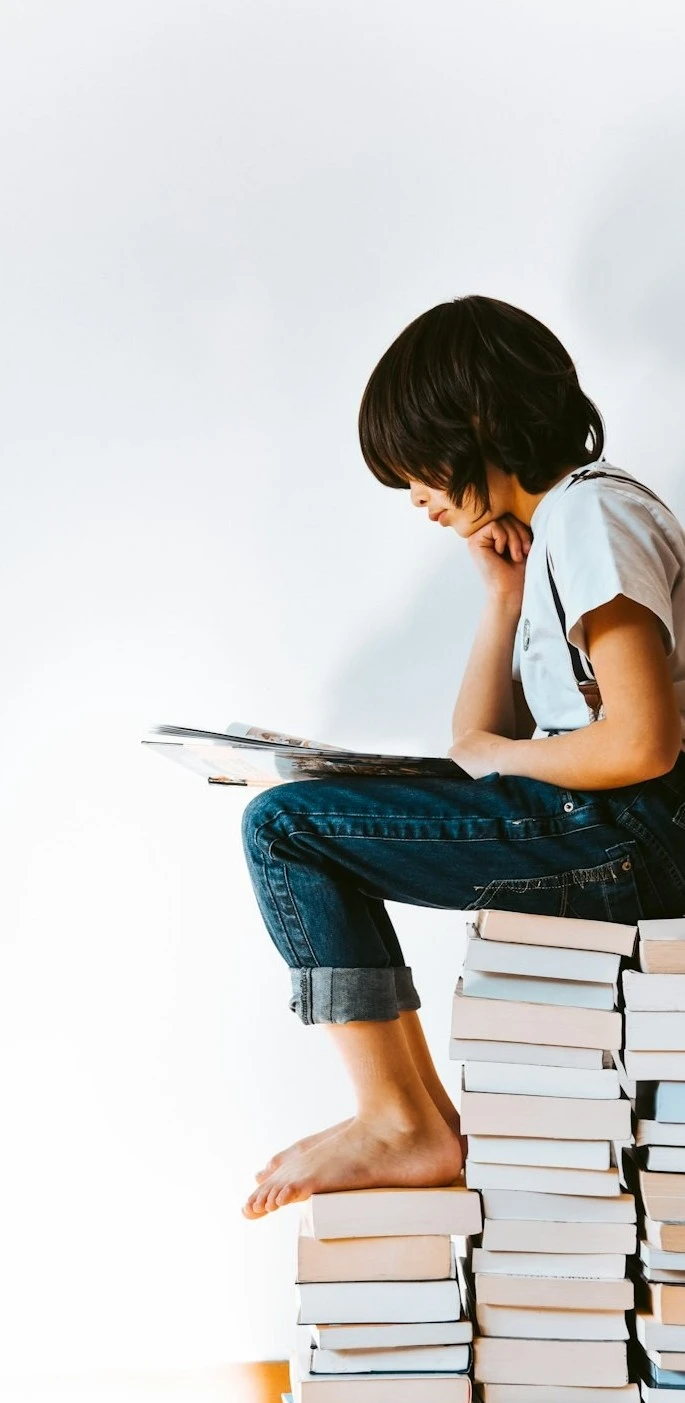 Child reading books as part of an educational support program