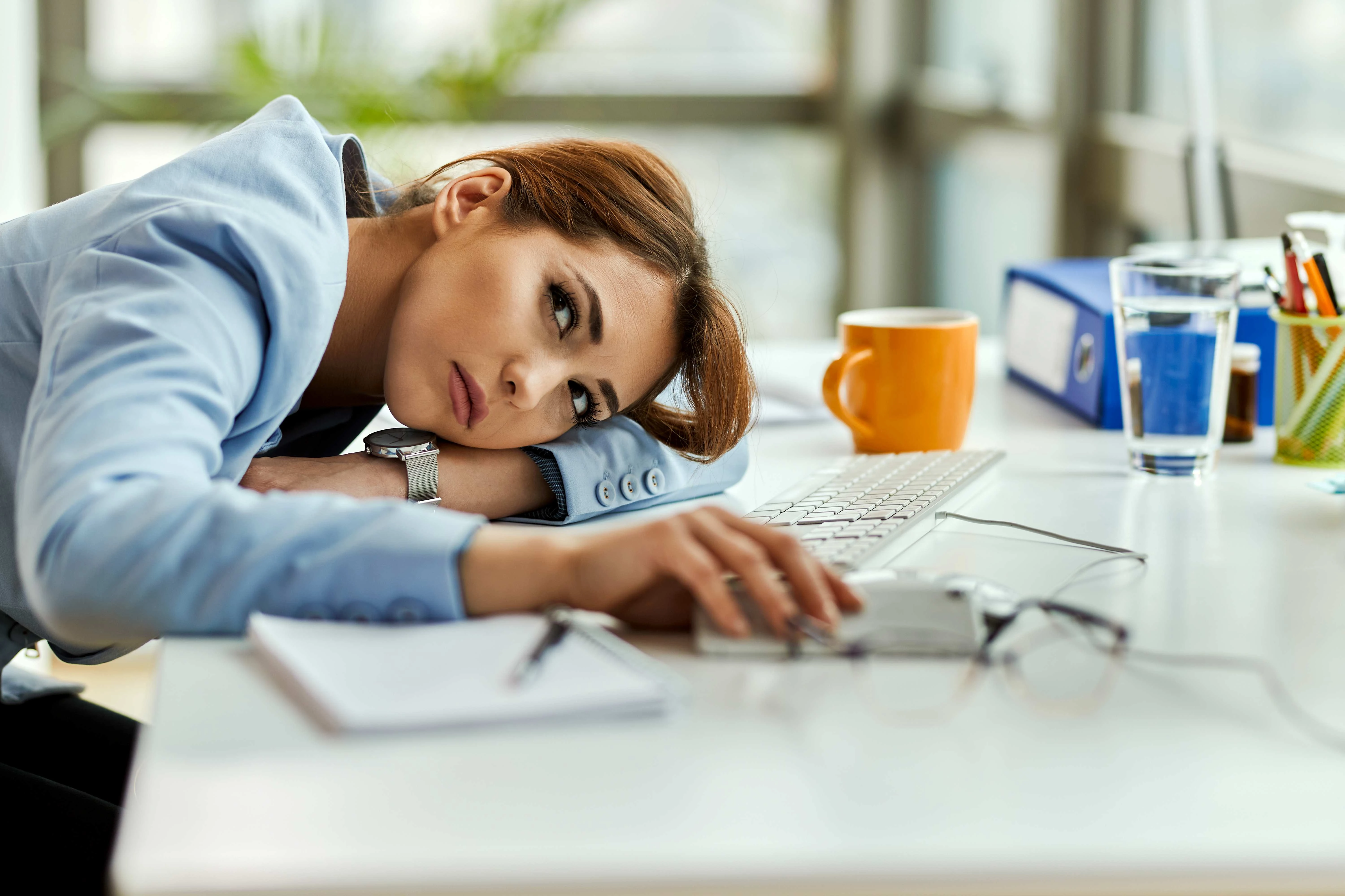 551-pensive-businesswoman-feeling-bored-resting-her-office-desk-17188794504948.jpg