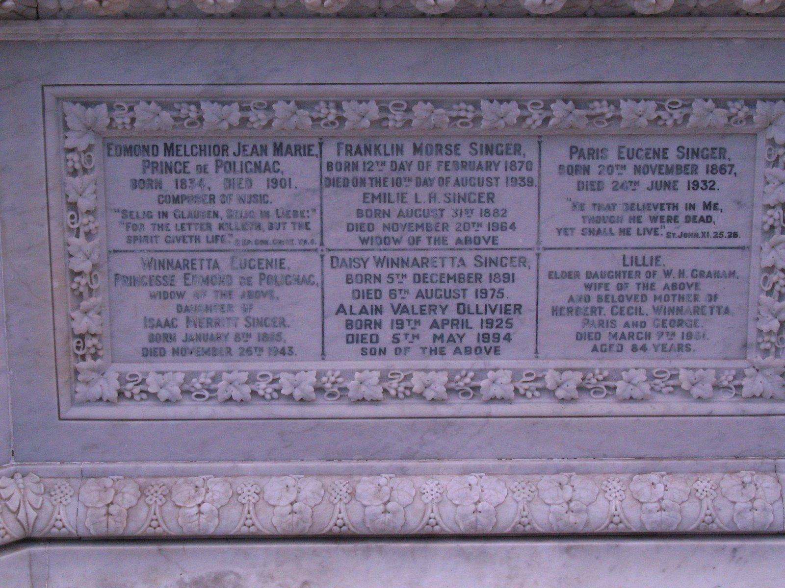 The Singer family memorial at Torquay Cemetery in Devon, England — adjoining the marble mausoleum where Isaac Merritt Singer himself was buried in 1875. Inscribed here are three of his children by Isabella Boyer: Winnaretta Eugénie, Princesse de Polignac (1865–1943); Paris Eugene Singer (1867–1932); Franklin Morse Singer (1870–1939); together with Winnaretta's husband Prince Edmond de Polignac, Paris's English wife Lillie Graham, and grandchildren. From a New York scoundrel's grave in a Devon cemetery, an entire European dynasty traces back.