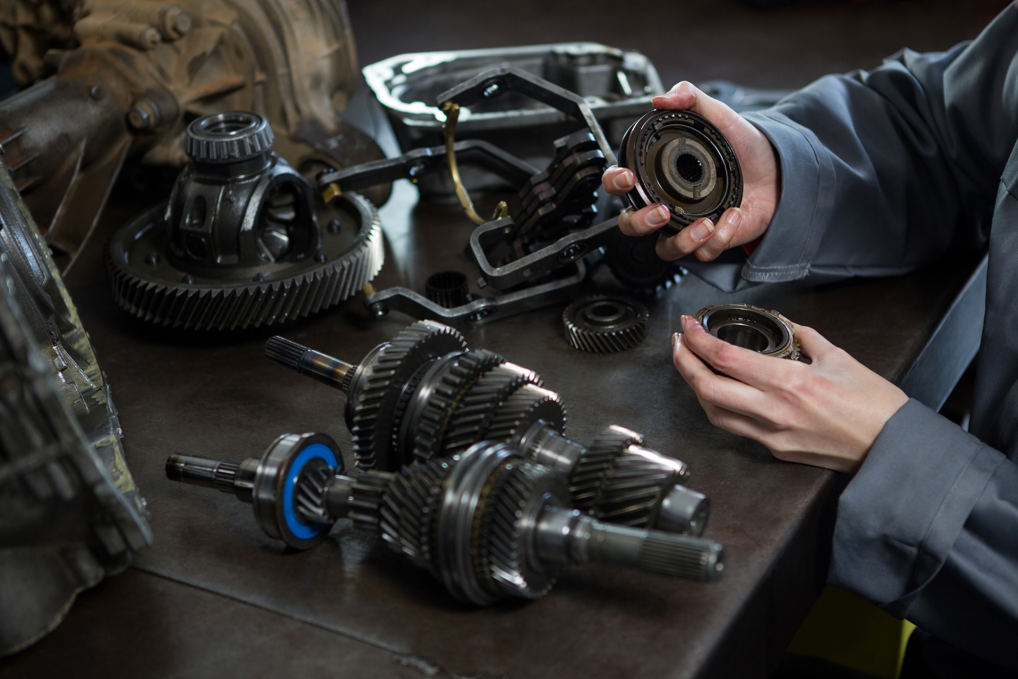 12-female-mechanic-holding-spare-parts-car.jpg