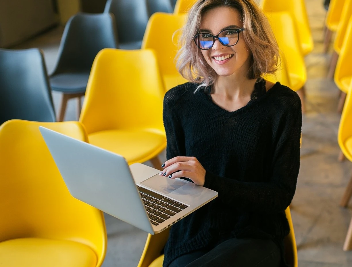 1101071225928453-portrait-young-attractive-woman-sitting-lecture-hall-working-laptop-wearing-glas.jpg