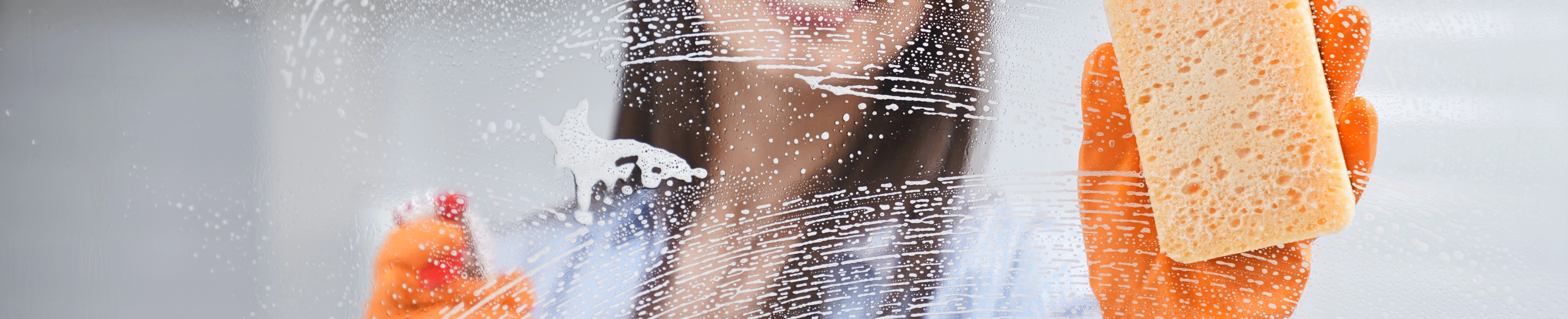 0184679521619164-beautiful-woman-washing-window-rubber-gloves-17407733482693.jpg