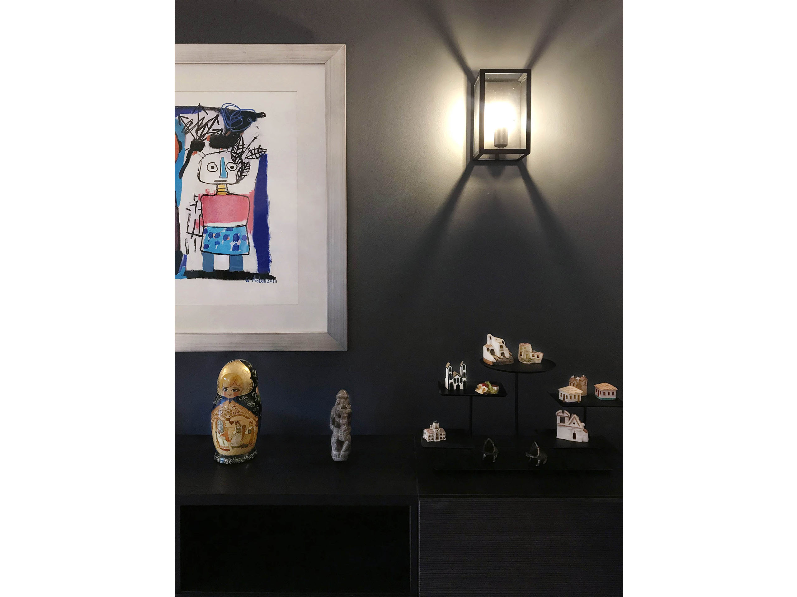 Modern dark charcoal wall with colorful art that stands out