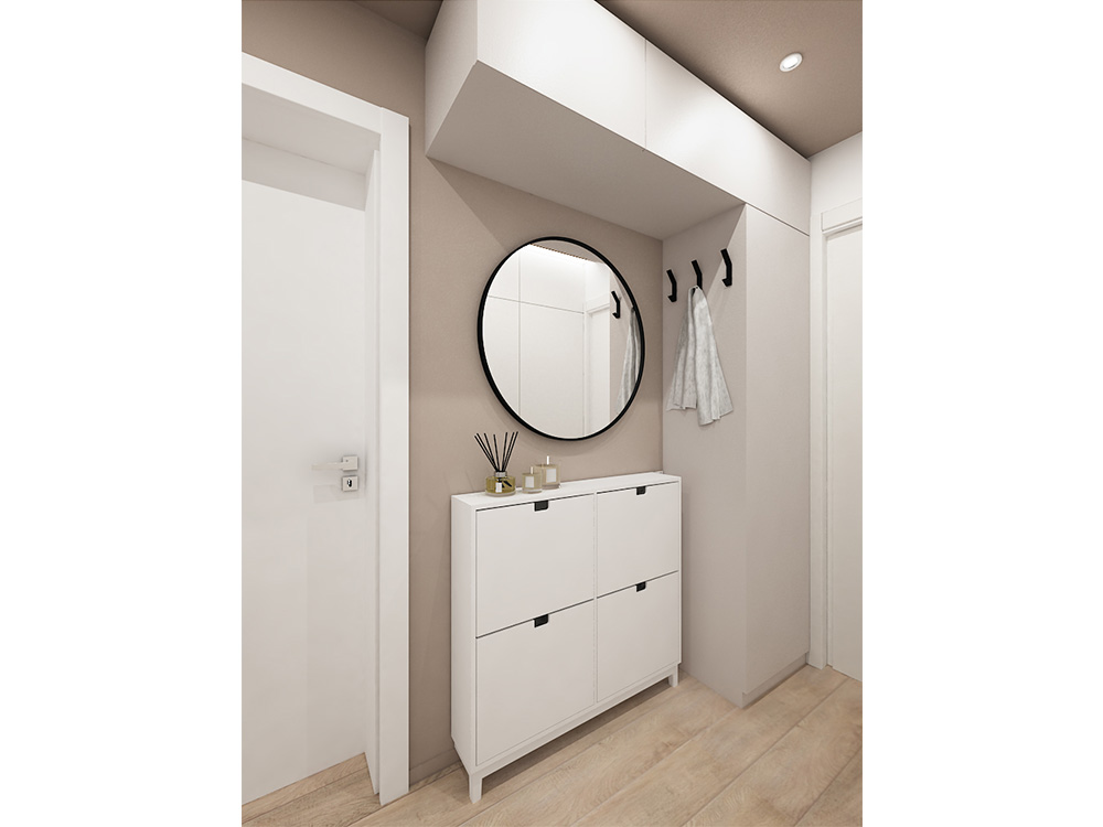 A functional entryway with a built-in wardrobe, a round mirror and an IKEA shoe cabinet in beige