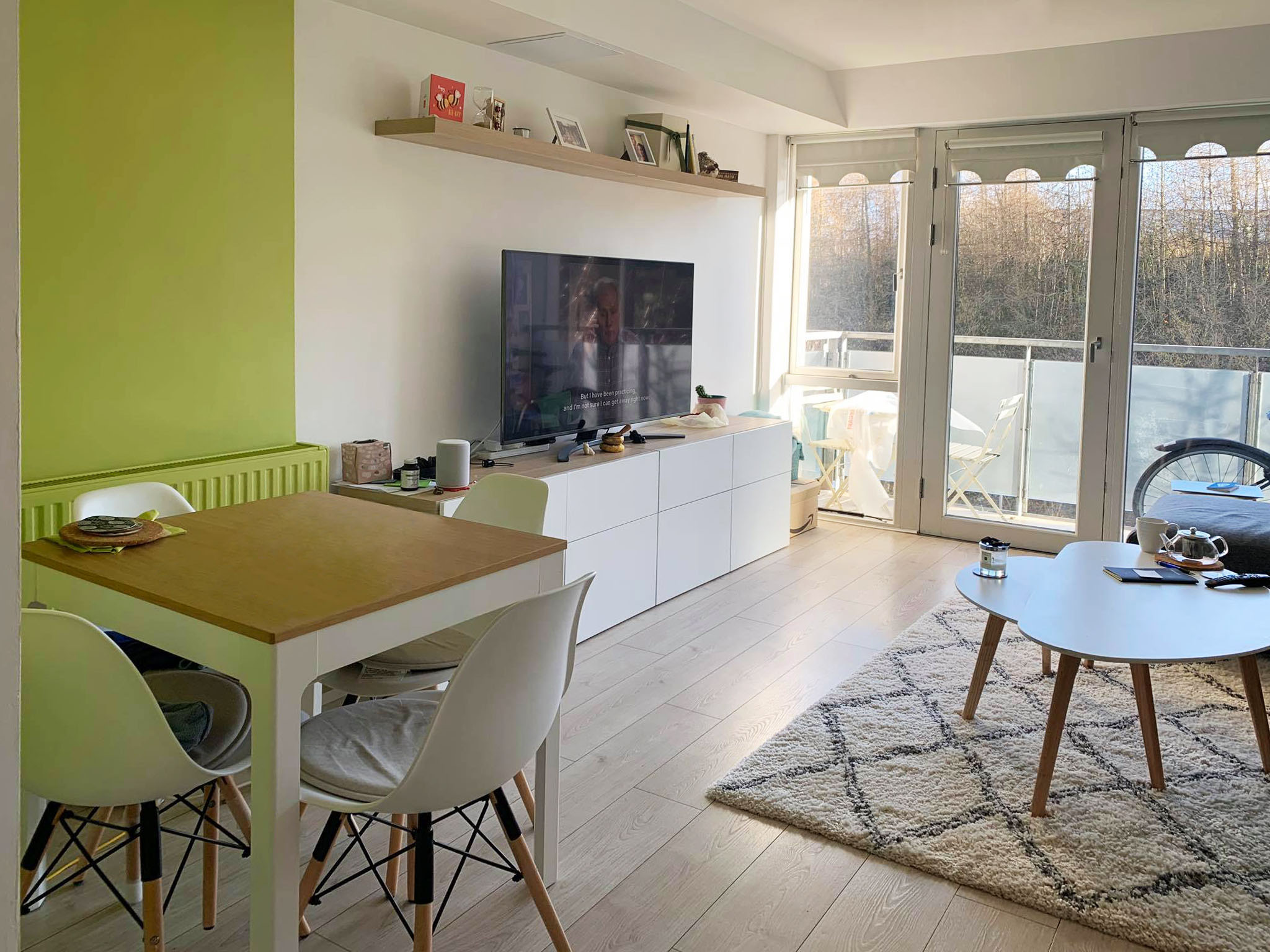 Tiny living room with small dining table in bright green