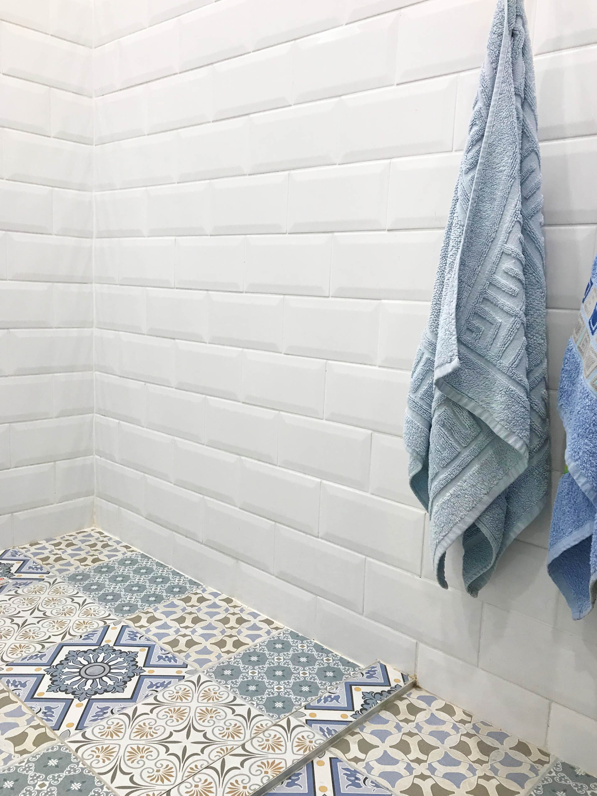 White and blue bathroom remodeling with blue textile