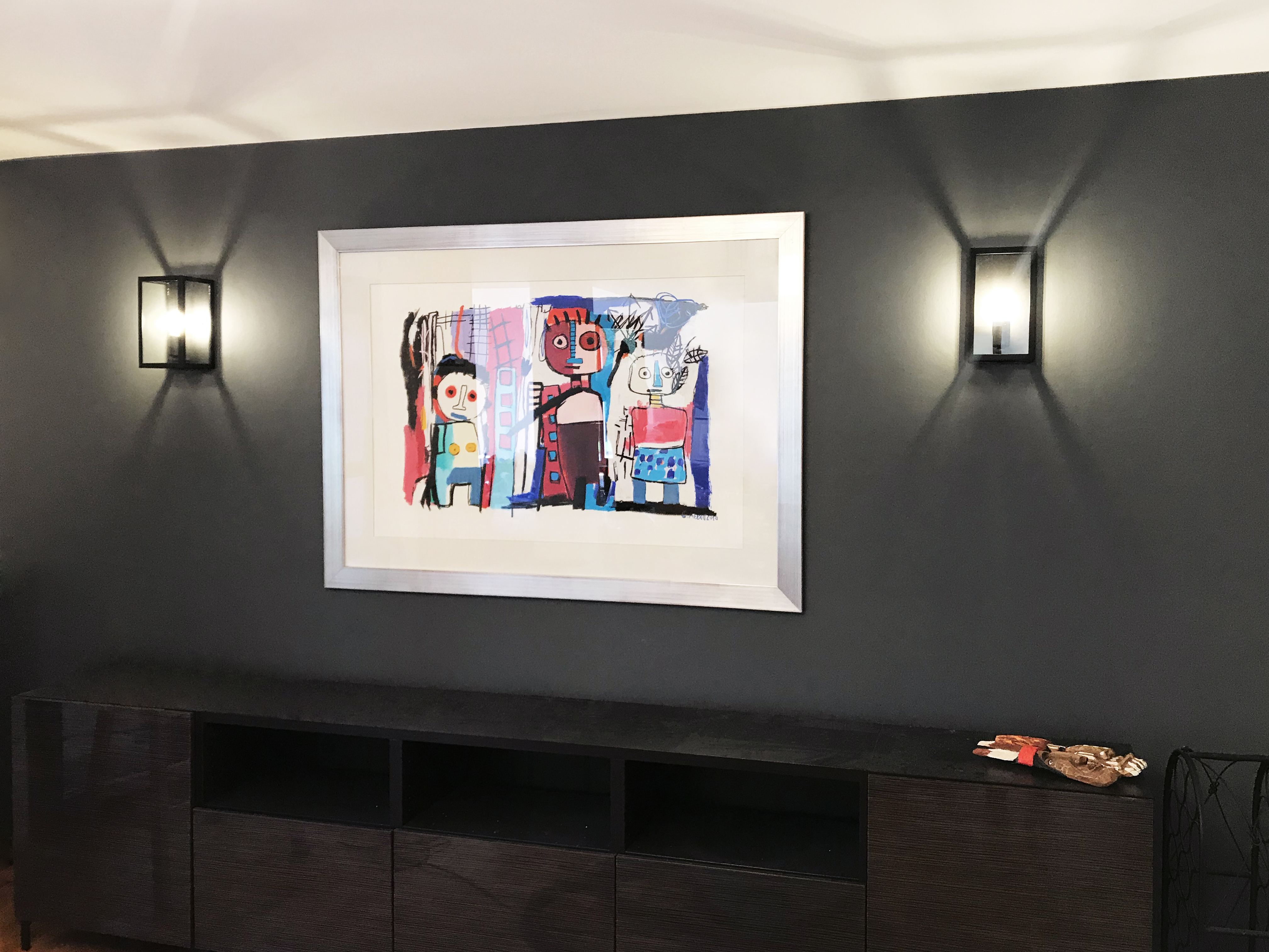 Modern dark charcoal wall with colorful art that stands out