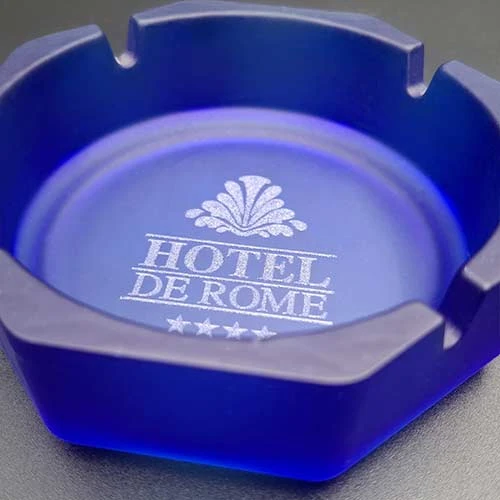 Син стъклен пепелник с гравирано лого на хотел