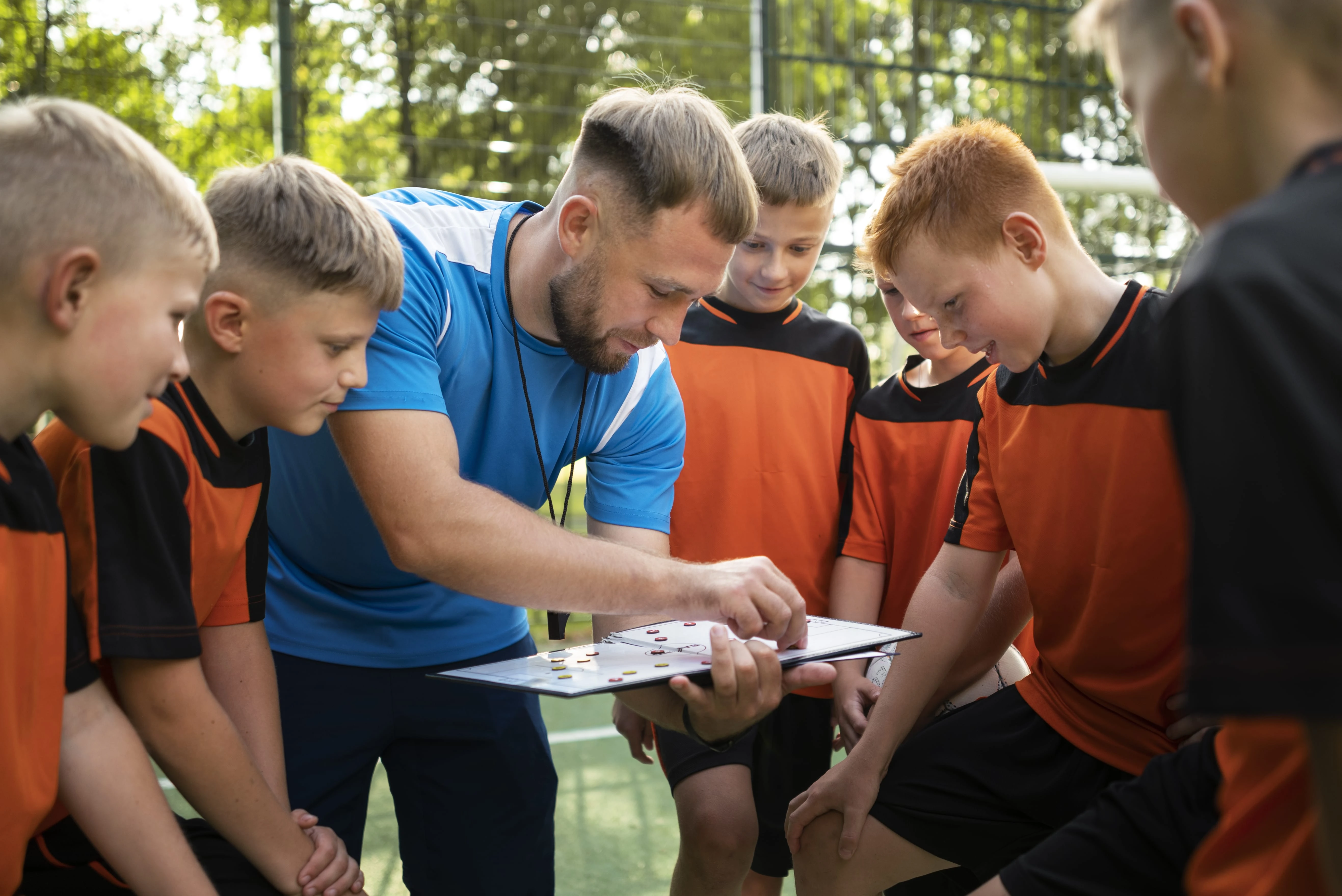 132-football-trainer-teaching-his-pupils-min-17327014145212.jpg