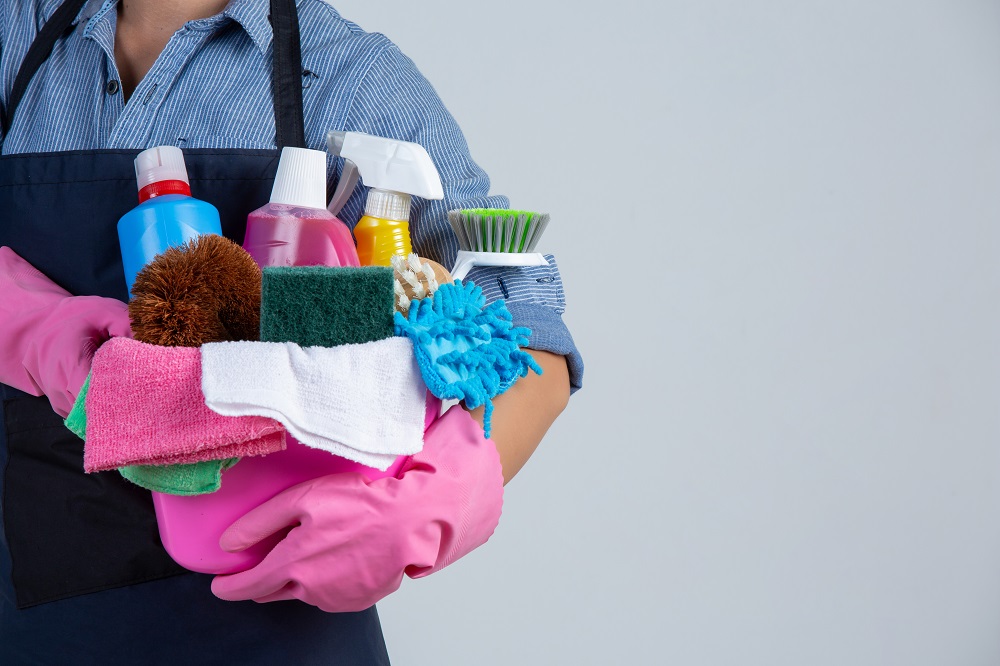 42-r35-young-girl-is-holding-cleaning-product-gloves-rags-basin-white-wall.jpg