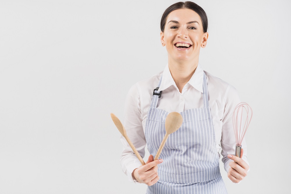 30-woman-apron-smiling-holding-utensil.jpg