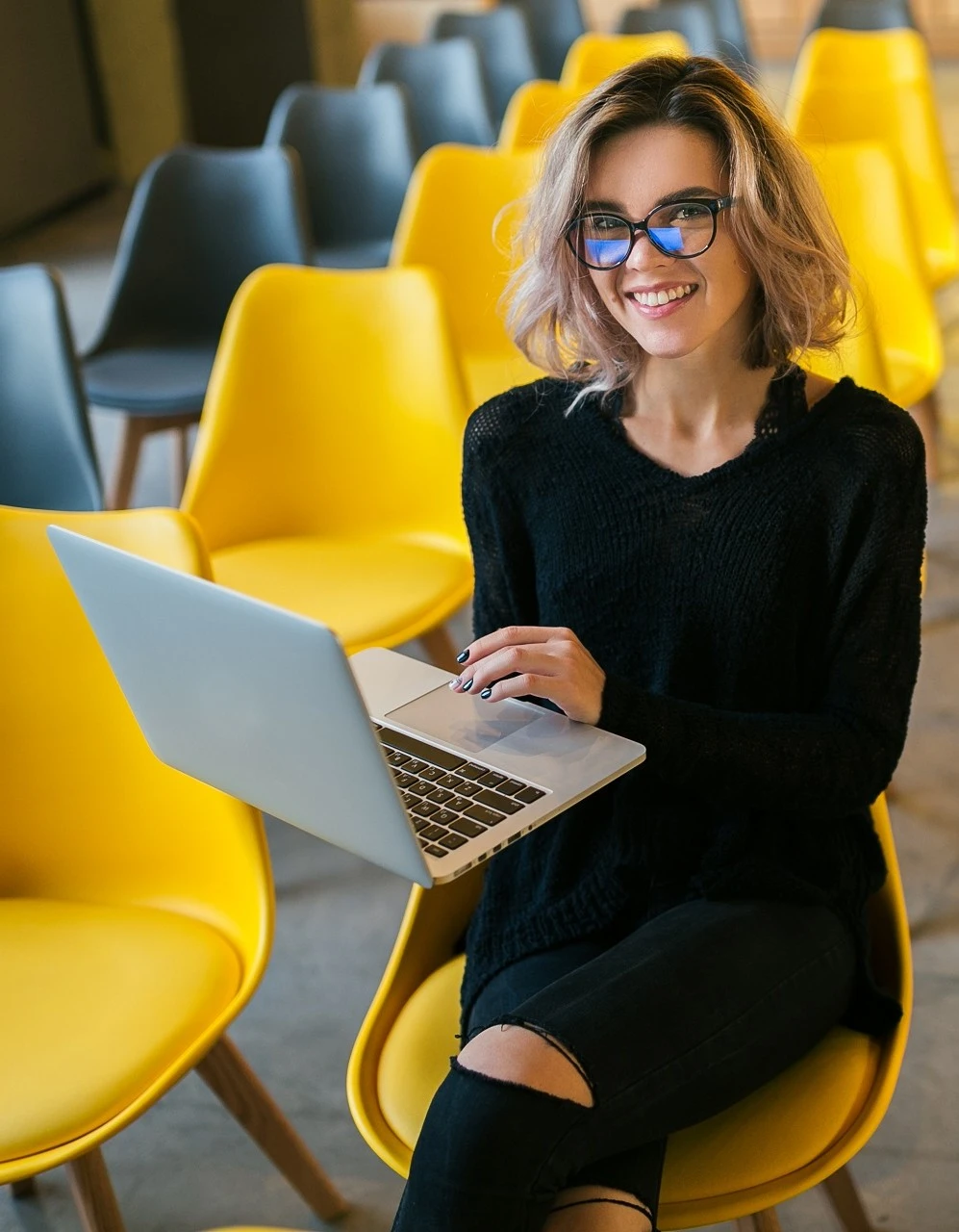 1970997128027-portrait-young-attractive-woman-sitting-lecture-hall-working-laptop-wearing-glas.jpg