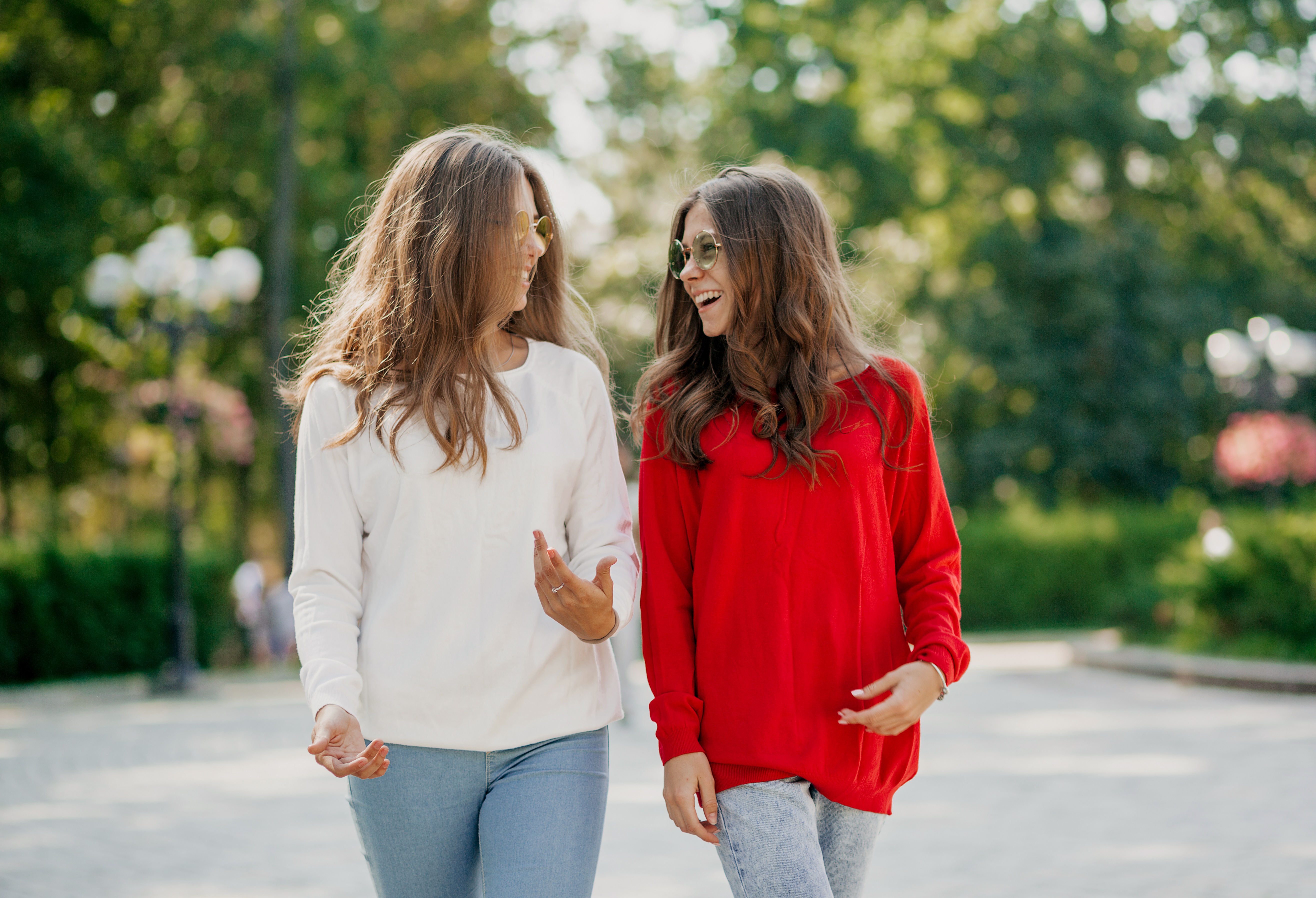 1125-two-elegant-girls-with-wavy-long-hairstyles-are-wearing-bright-shirts-are-talkin.jpg