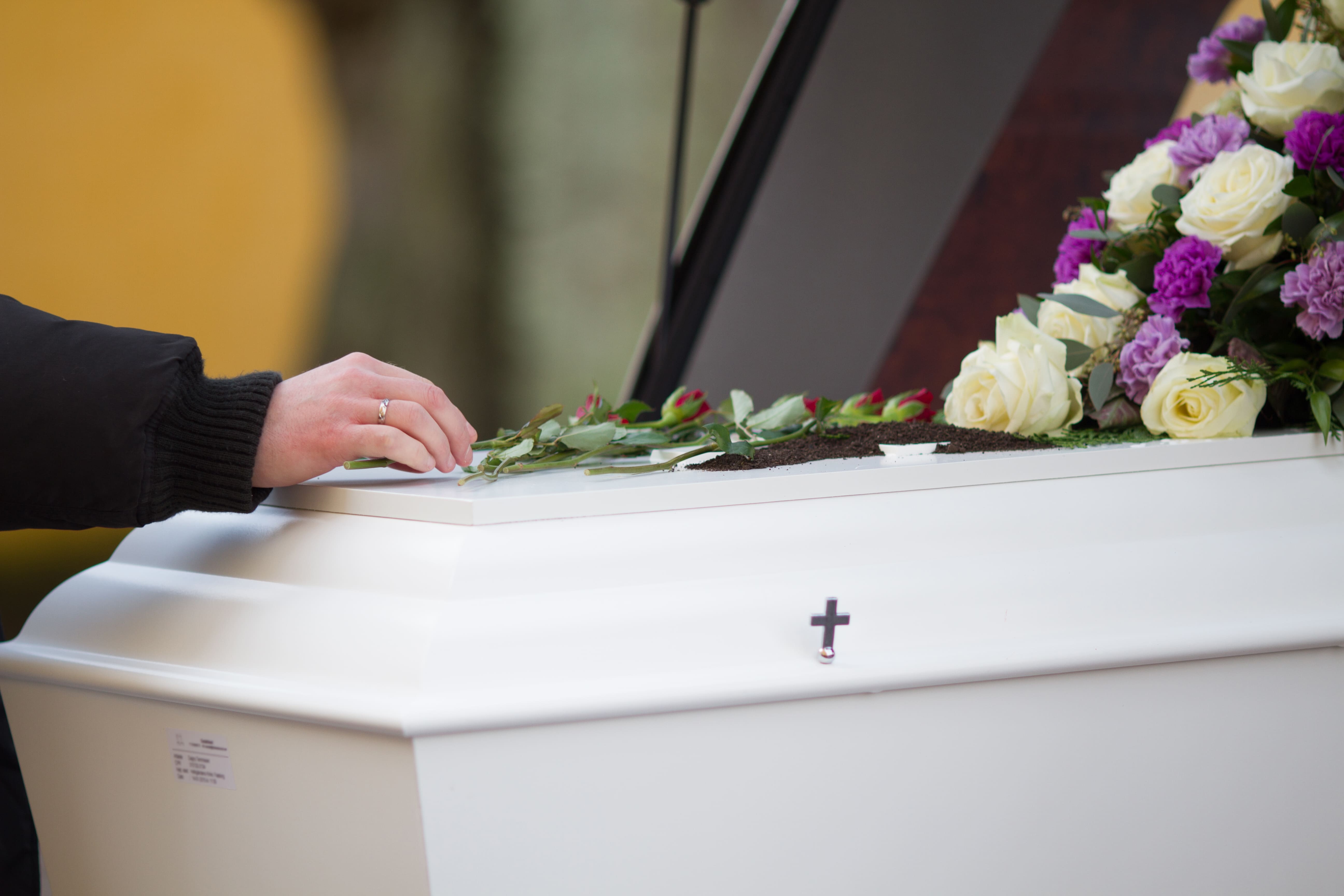 122-closeup-shot-person-hand-casket-with-blurred-background-17684014135106.jpg