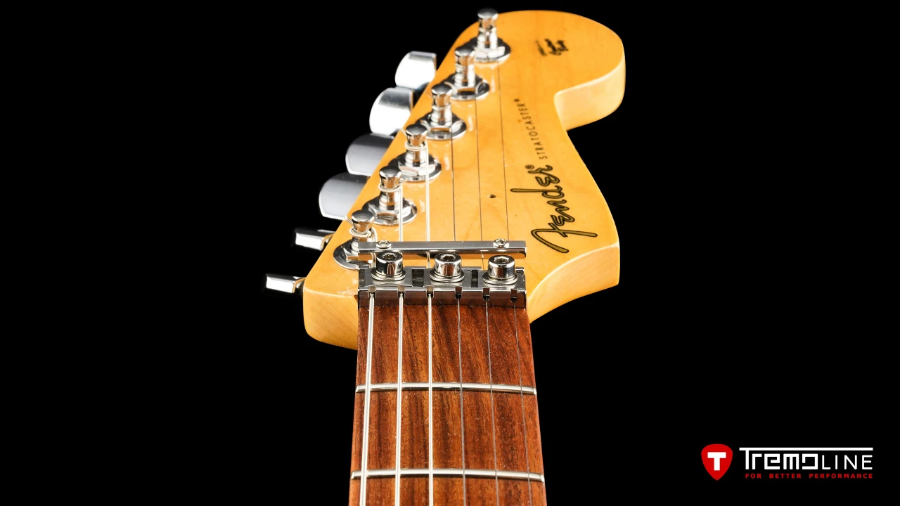 <img src=”Tremoline-guitar-double-locking-tremolo-Fender-Stratocaster-RH-1280x720-J3C.jpg” width="1280" height="720" alt=”Tremoline LN6A locking nut on Fender Stratocaster RH guitar” />