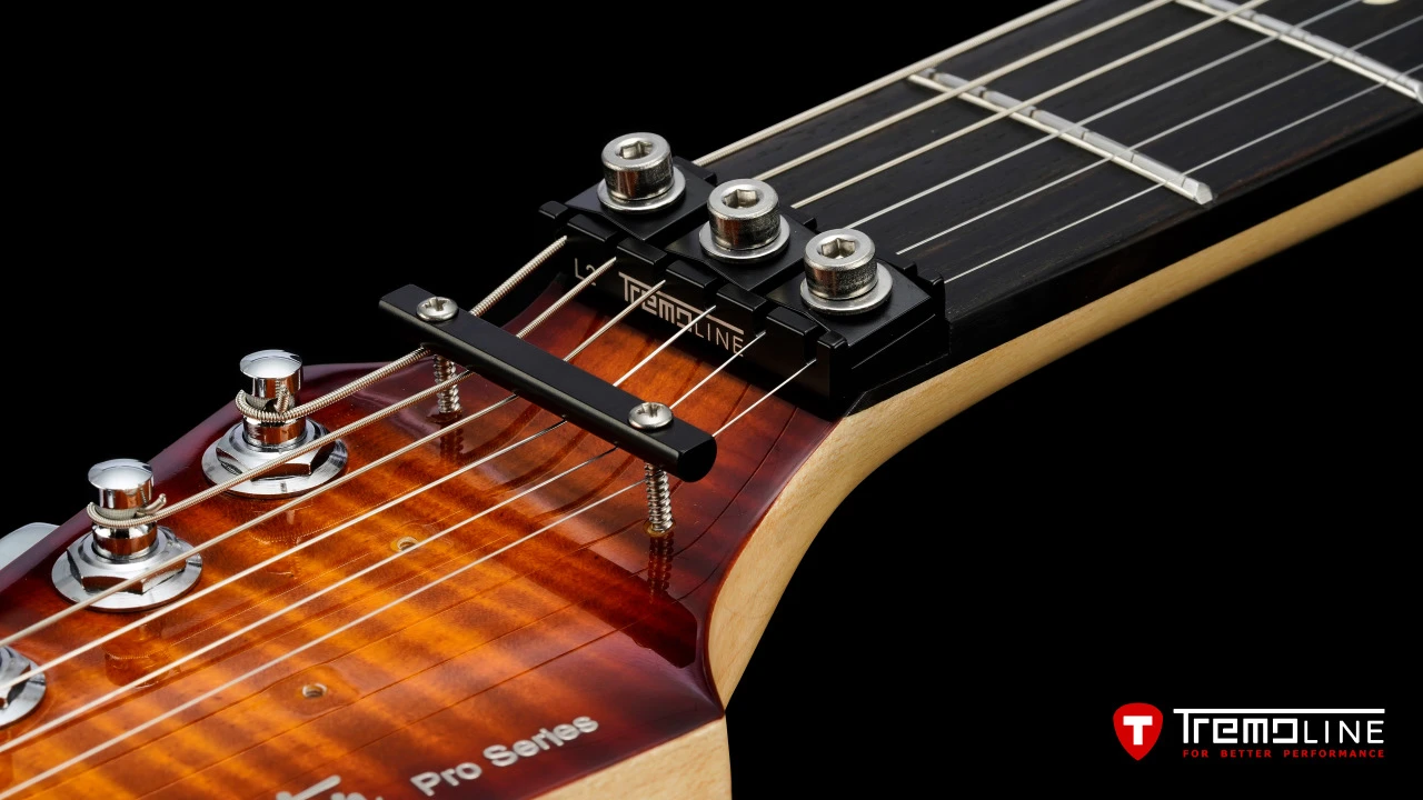 <img src=”Tremoline-guitar-double-locking-tremolo-Harley-Benton-Fusion-LH-1280x720-I3A.jpg” width="1280" height="720" alt=”Tremoline LN6A locking nut on Harley Benton Fusion III LH guitar” />