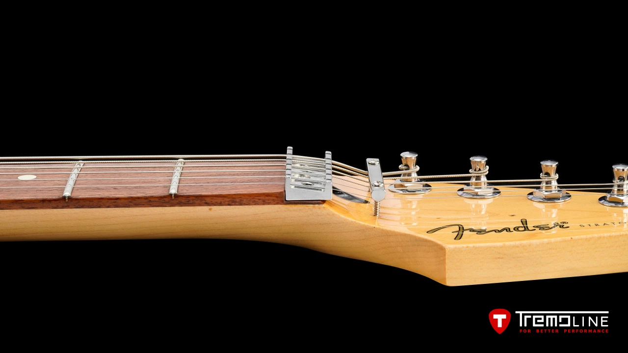 <img src=”Tremoline-guitar-tremolo-Fender-Stratocaster-RH-1280x720-07.jpg” width="1280" height="720" alt=”Tremoline LN6A locking nut on Fender Stratocaster RH guitar” />