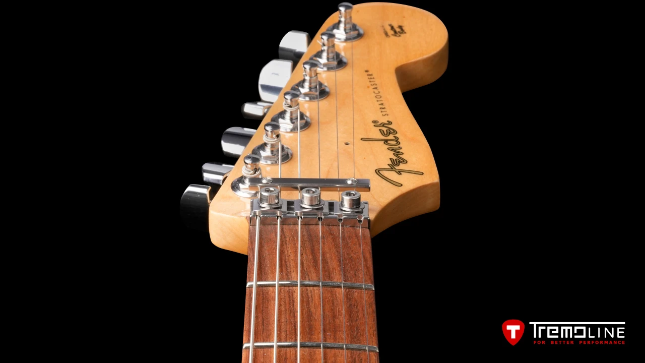 <img src=”Tremoline-guitar-tremolo-Fender-Stratocaster-RH-1280x720-08.jpg” width="1280" height="720" alt=”Tremoline LN6A locking nut on Fender Stratocaster RH guitar” />