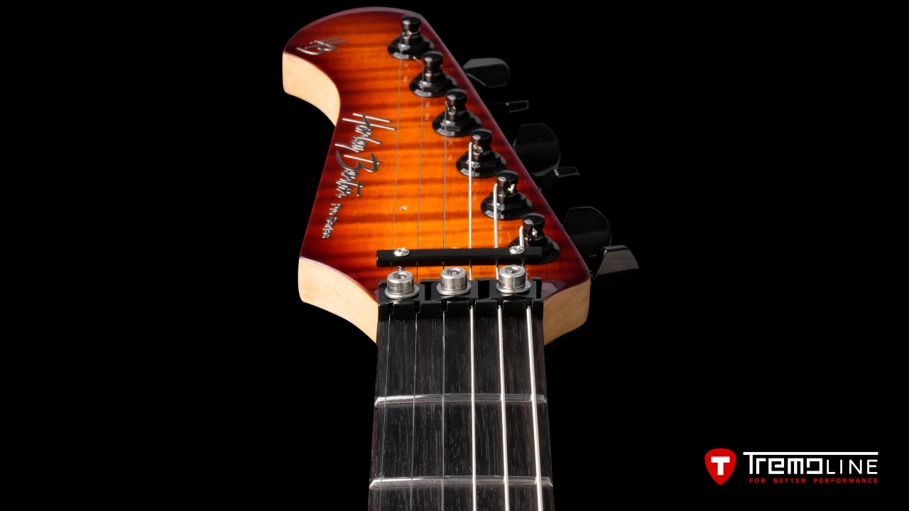 <img src=”Tremoline-guitar-tremolo-Harley-Benton-Fusion-LH-1280x720-07.jpg” width="1280" height="720" alt=”Tremoline LN6A locking nut on Harley Benton Fusion III LH guitar” />