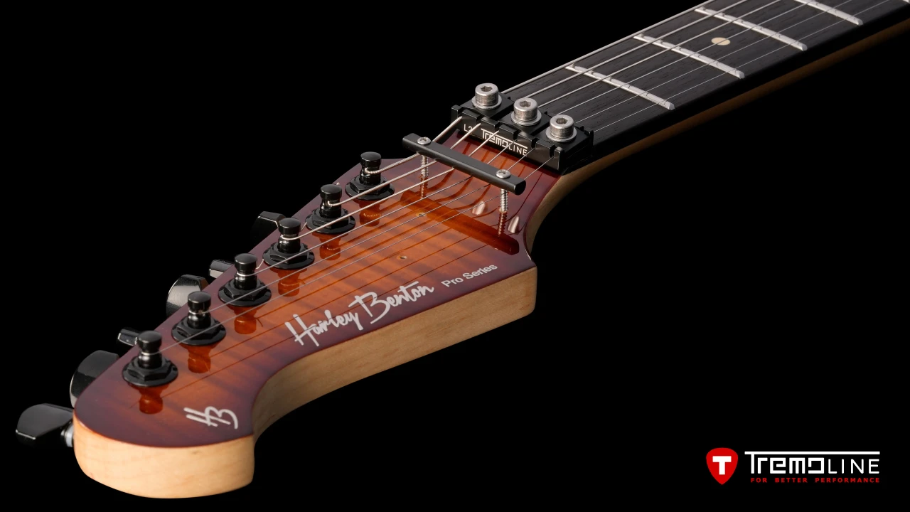 <img src=”Tremoline-guitar-tremolo-Harley-Benton-Fusion-LH-1280x720-09.jpg” width="1280" height="720" alt=”Tremoline LN6A locking nut on Harley Benton Fusion III LH guitar” />