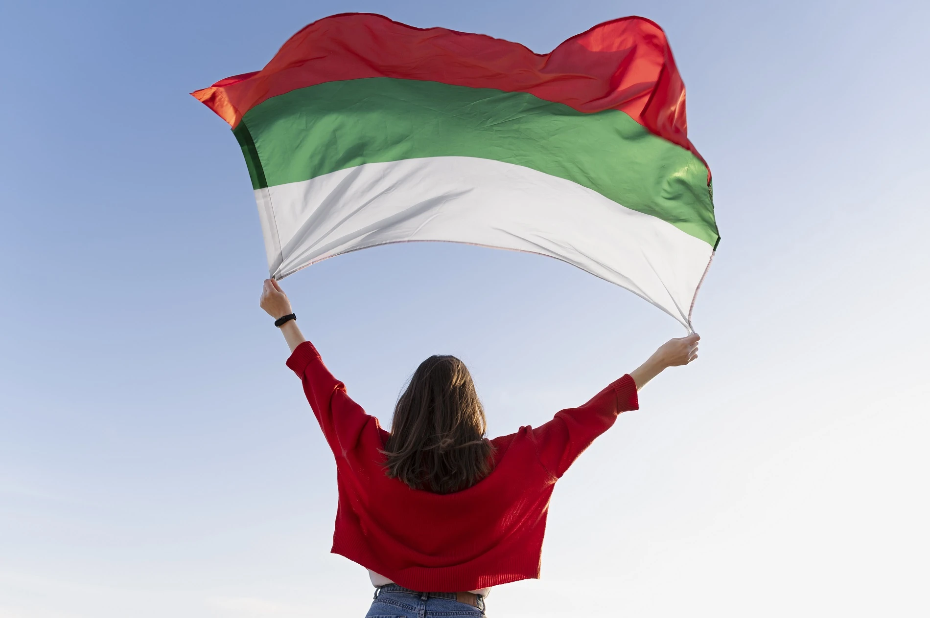 93-woman-holding-bulgarian-flag-against-blue-flag-17085152015954.jpg