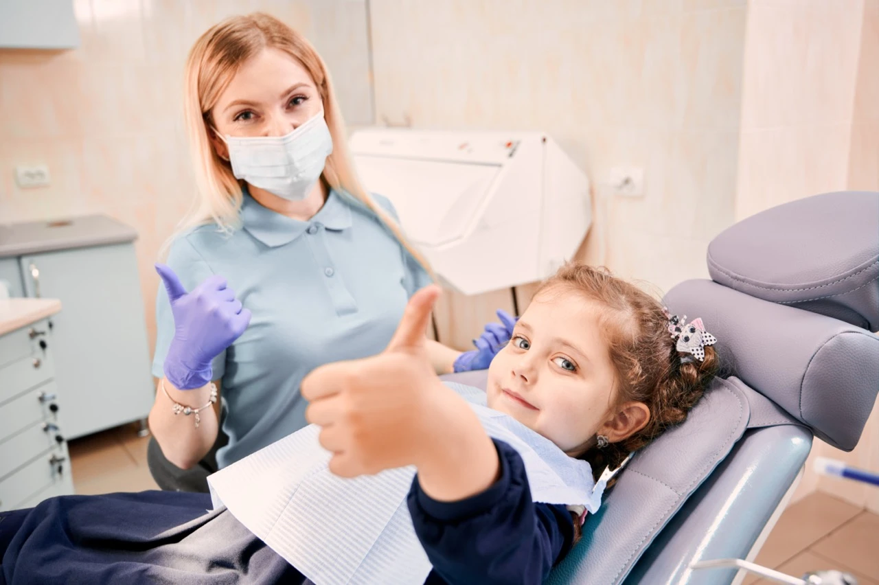 888-female-dentist-cute-little-girl-giving-thumbs-up-large-17871474542609.jpeg