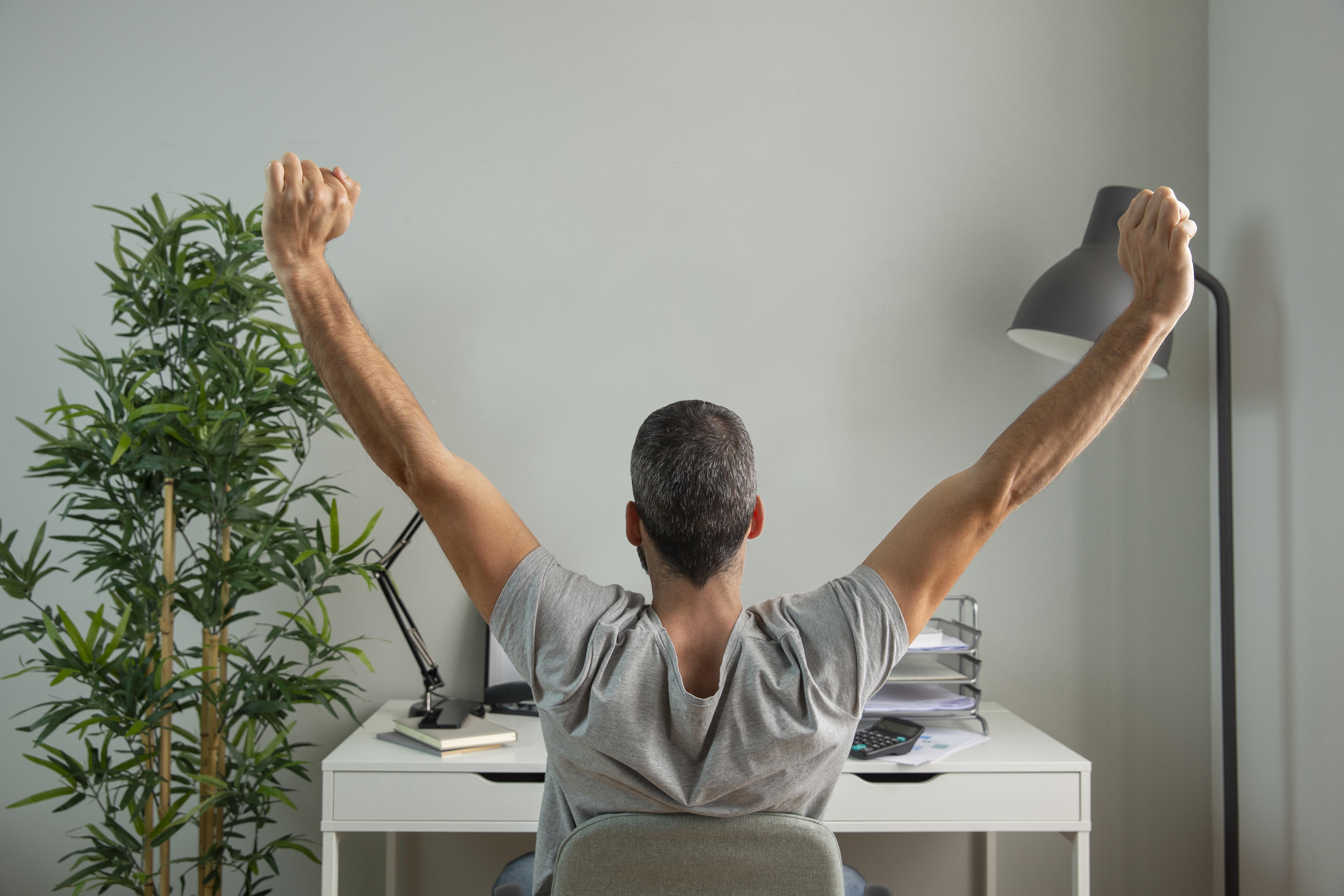 84-back-view-man-stretching-his-arms-while-working-from-home.jpg